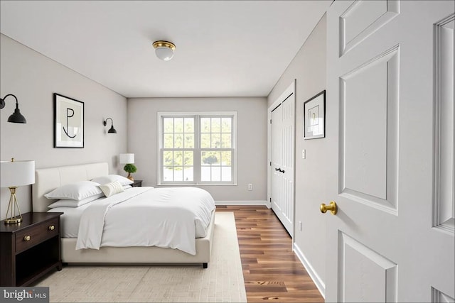  - bedroom featuring wood finished floors and baseboards