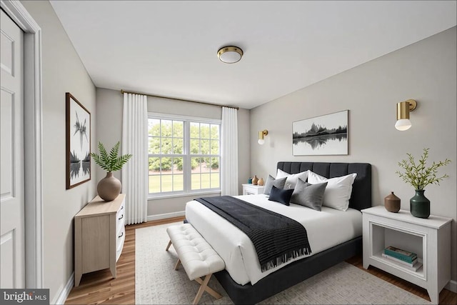  - bedroom featuring wood finished floors and baseboards