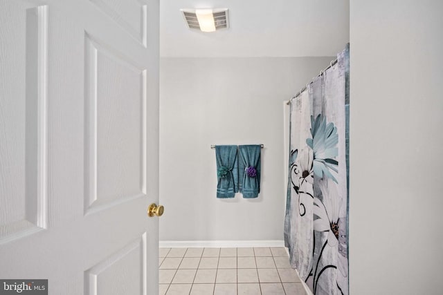  - full bath with tile patterned flooring and baseboards