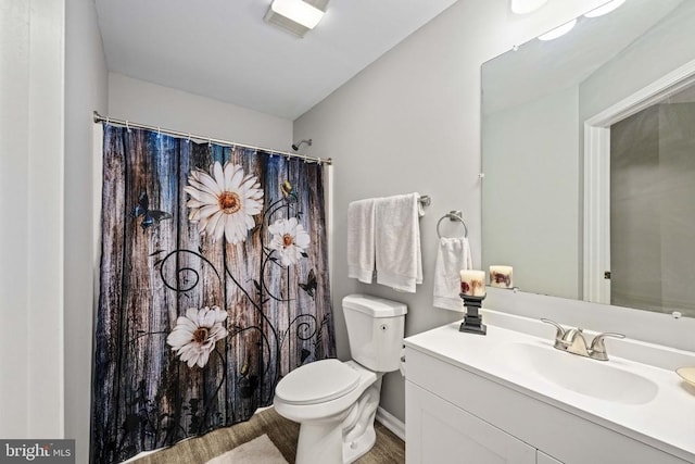  - bathroom with toilet, wood finished floors, vanity, and a shower with curtain