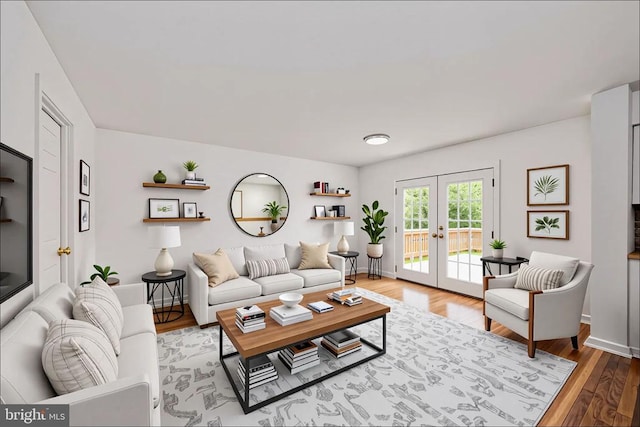  - living room with french doors, wood finished floors, and baseboards