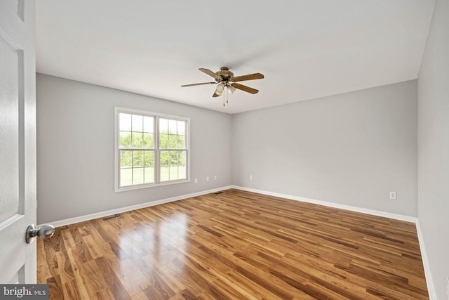  - spare room with a ceiling fan, baseboards, and wood finished floors