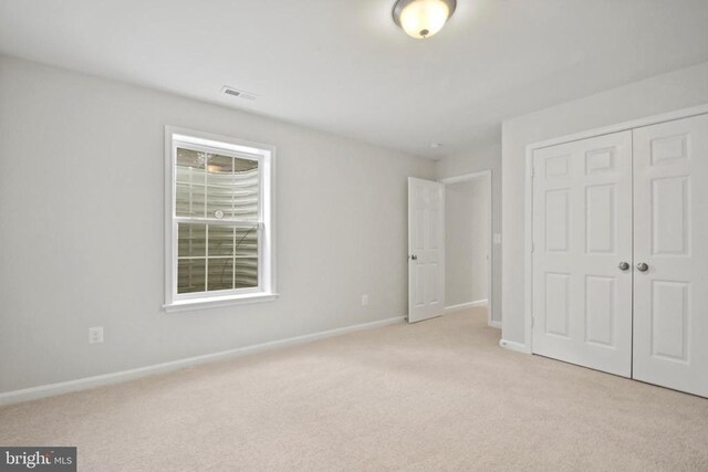 2042 Mourning Dove Dr, Locust Grove, VA 22508 - unfurnished bedroom featuring light colored carpet, a spacious closet, ensuite bath, and a ceiling fan