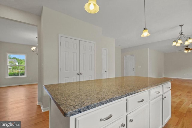 2042 Mourning Dove Dr, Locust Grove, VA 22508 - kitchen featuring a chandelier, open floor plan, light wood finished floors, and dark stone countertops
