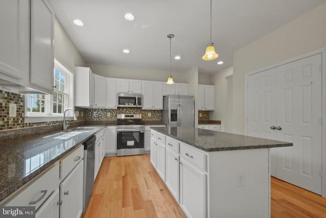 2042 Mourning Dove Dr, Locust Grove, VA 22508 - kitchen with stainless steel appliances, white cabinetry, light wood-style flooring, decorative backsplash, and recessed lighting