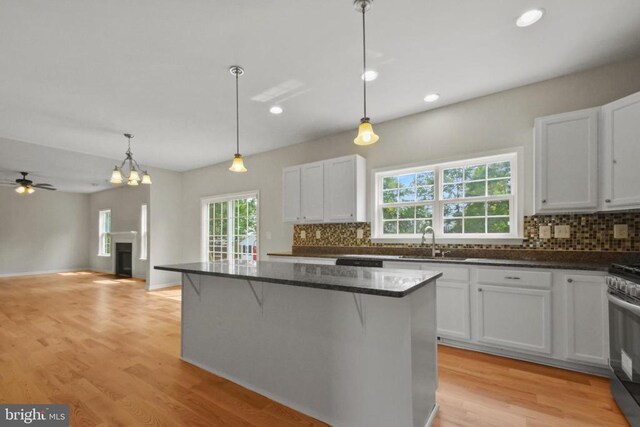 2042 Mourning Dove Dr, Locust Grove, VA 22508 - kitchen with stainless steel appliances, a chandelier, backsplash, dark countertops, and white cabinetry