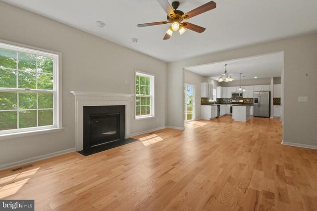 2042 Mourning Dove Dr, Locust Grove, VA 22508 - unfurnished bedroom featuring light colored carpet, a spacious closet, ensuite bath, and a ceiling fan