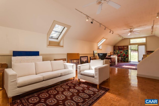 3 Old Mill Rd, Warm Springs, VA 24484 - living room with wainscoting, rail lighting, ceiling fan, and vaulted ceiling with skylight