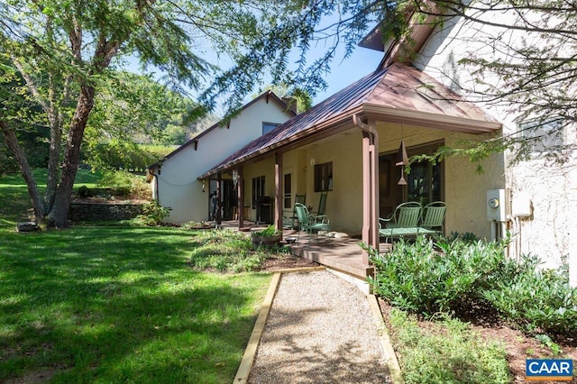 3 Old Mill Rd, Warm Springs, VA 24484 - back of property with a patio, stucco siding, metal roof, a lawn, and a standing seam roof