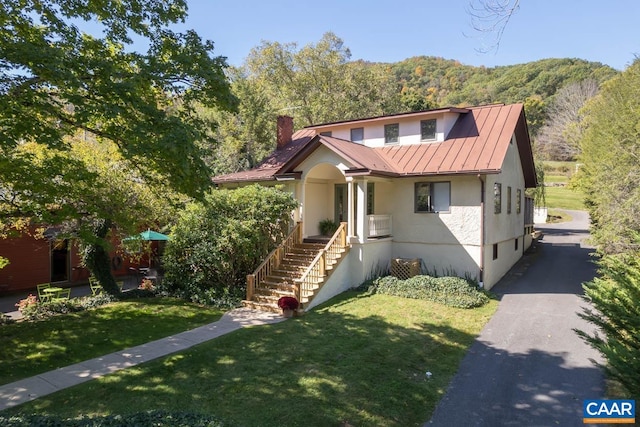 3 Old Mill Rd, Warm Springs, VA 24484 - bungalow-style house featuring stucco siding, a chimney, metal roof, a front yard, and a standing seam roof