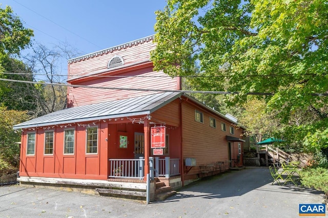 3 Old Mill Rd, Warm Springs, VA 24484 - view of property exterior with metal roof, a porch, and a standing seam roof
