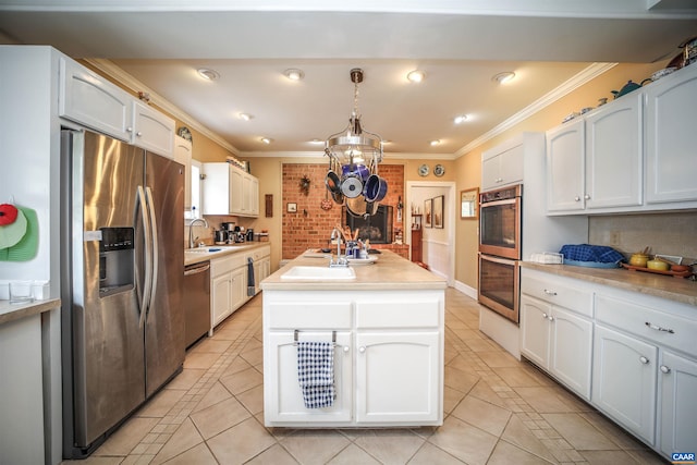 325 Union Run, Lexington, VA 24450 - kitchen with stainless steel appliances, a sink, light tile patterned floors, crown molding, and a kitchen island with sink