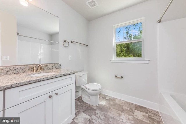 bathroom featuring toilet, baseboards, vanity, and bathing tub / shower combination