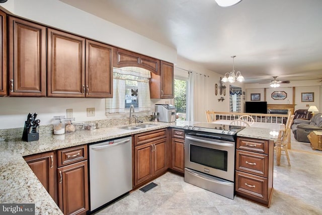 11911 Smoketree Blvd, Fredericksburg, VA 22407 - kitchen featuring a sink, a peninsula, stainless steel appliances, light stone counters, and open floor plan