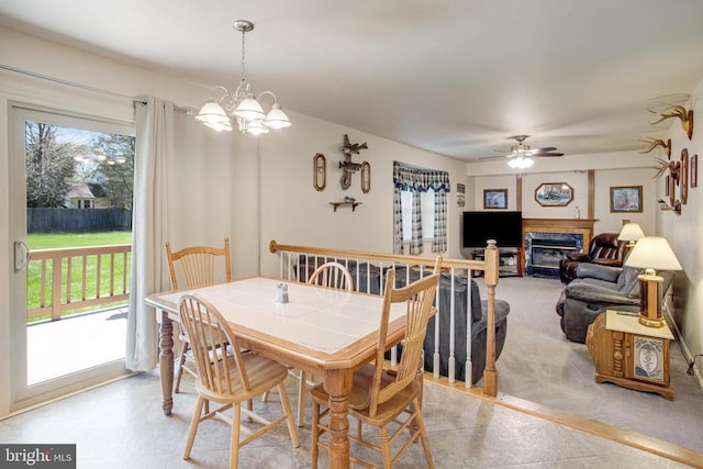 11911 Smoketree Blvd, Fredericksburg, VA 22407 - dining space featuring light carpet, ceiling fan with notable chandelier, and a glass covered fireplace