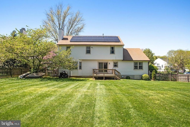 11911 Smoketree Blvd, Fredericksburg, VA 22407 - rear view of property featuring a lawn, a wooden deck, solar panels, and a fenced backyard