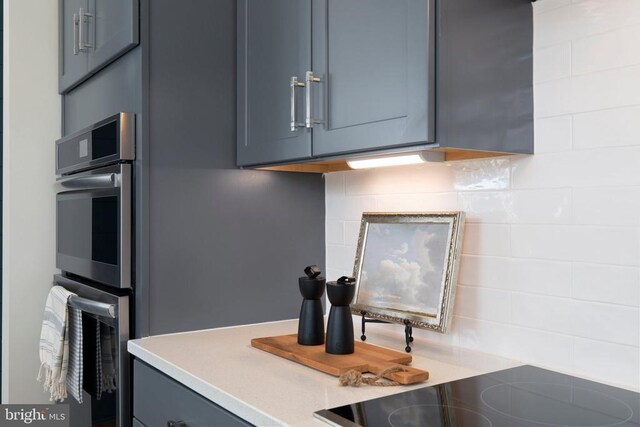 10501 Afton Grove Ct, Fredericksburg, VA 22408 - kitchen with double oven, backsplash, gray cabinets, light countertops, and black electric stovetop