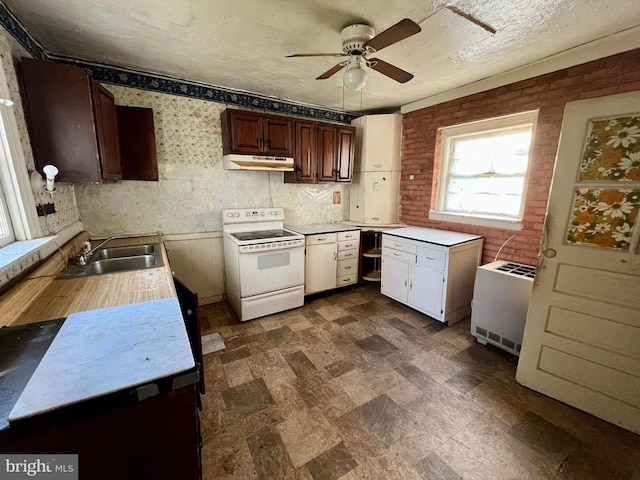 120 Charles St, Gordonsville, VA 22942 - kitchen with white range with electric stovetop, under cabinet range hood, a ceiling fan, a sink, and light countertops