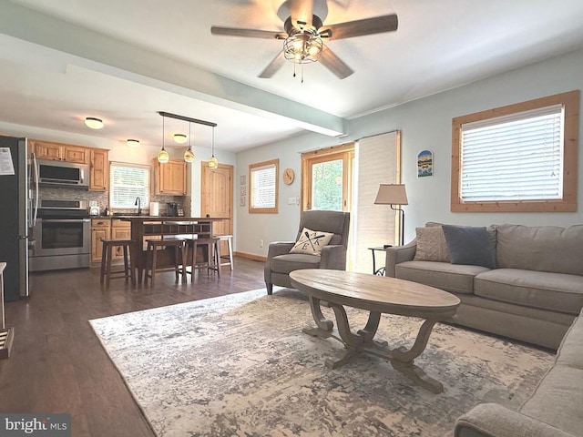 198 Miltons Ln, Louisa, VA 23093 - living area with a ceiling fan, plenty of natural light, dark wood finished floors, and beamed ceiling