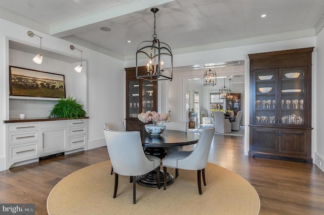 dining area featuring a chandelier, dark wood-type flooring, recessed lighting, and crown molding