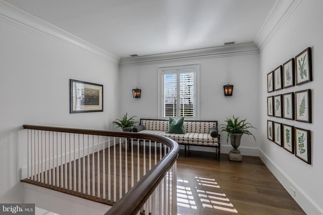 sitting room with crown molding, wood finished floors, and baseboards