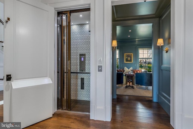 - corridor featuring wood finished floors and ornamental molding