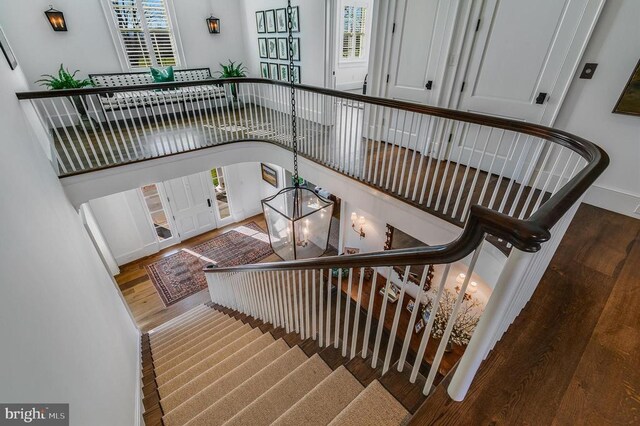 stairway featuring wood finished floors and baseboards