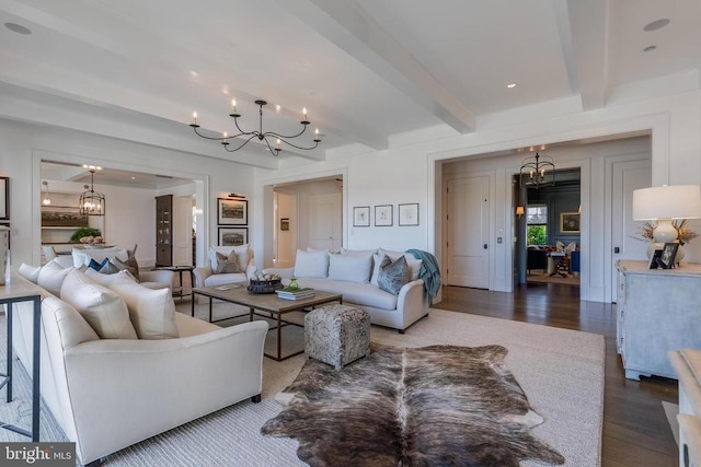 living area featuring a chandelier, dark wood-style floors, and beamed ceiling