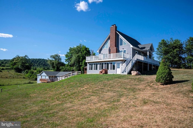 32 Old Hollow Rd, Sperryville, VA 22740 - rear view of house featuring a chimney, a wooden deck, fence, stairway, and a yard