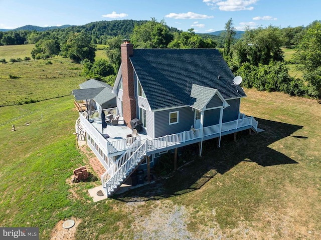 32 Old Hollow Rd, Sperryville, VA 22740 - back of property with a shingled roof, a yard, a deck with mountain view, and a chimney