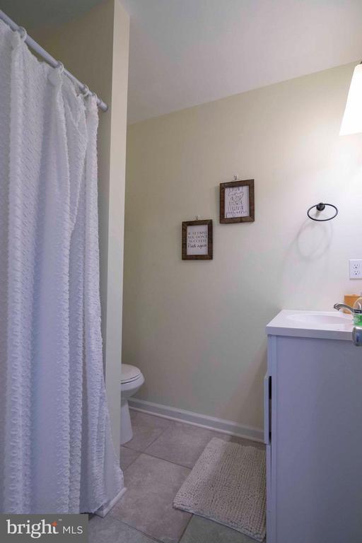 32 Old Hollow Rd, Sperryville, VA 22740 - full bathroom with toilet, a shower with curtain, baseboards, tile patterned flooring, and vanity