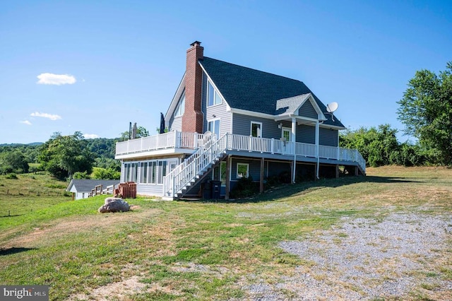 32 Old Hollow Rd, Sperryville, VA 22740 - back of property featuring a yard, a chimney, stairway, and a wooden deck