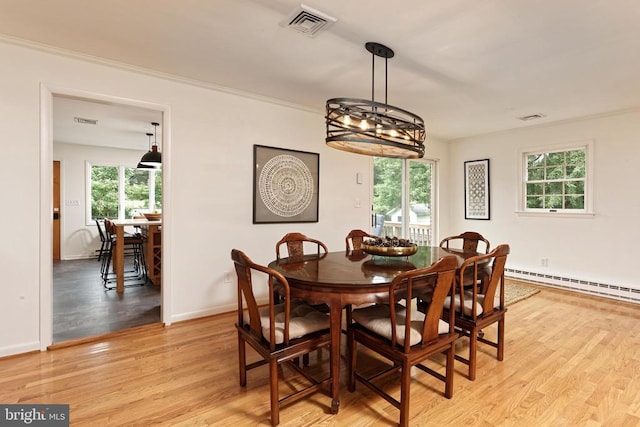  - dining space featuring light wood-type flooring and a chandelier