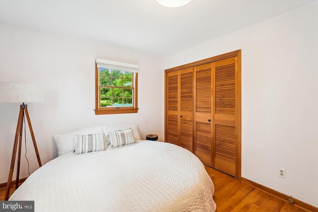  - bedroom featuring a closet and wood finished floors
