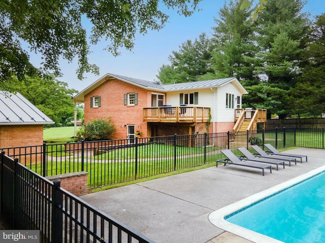  - back of property featuring stairway, a standing seam roof, brick siding, and a patio