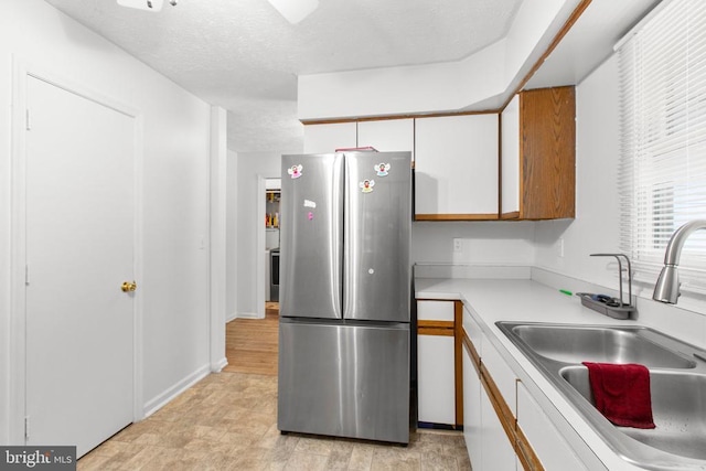 103 Patrick Henry Ct, Locust Grove, VA 22508 - kitchen featuring freestanding refrigerator, light countertops, white cabinetry, and a textured ceiling