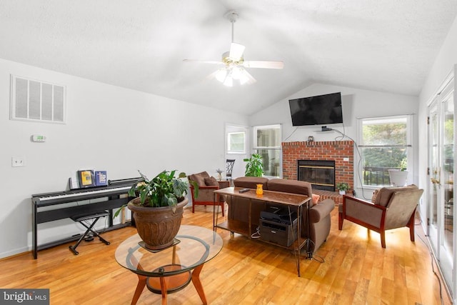 103 Patrick Henry Ct, Locust Grove, VA 22508 - living area with vaulted ceiling, a fireplace, light wood-type flooring, and ceiling fan