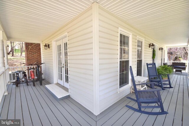  - deck featuring covered porch and french doors