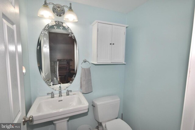  - half bathroom featuring a sink and toilet