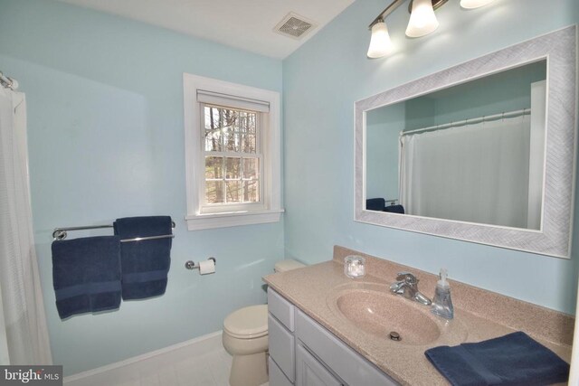  - full bathroom with vanity, toilet, and baseboards