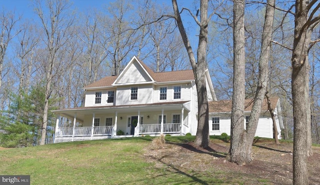 - view of front facade featuring covered porch and a front lawn