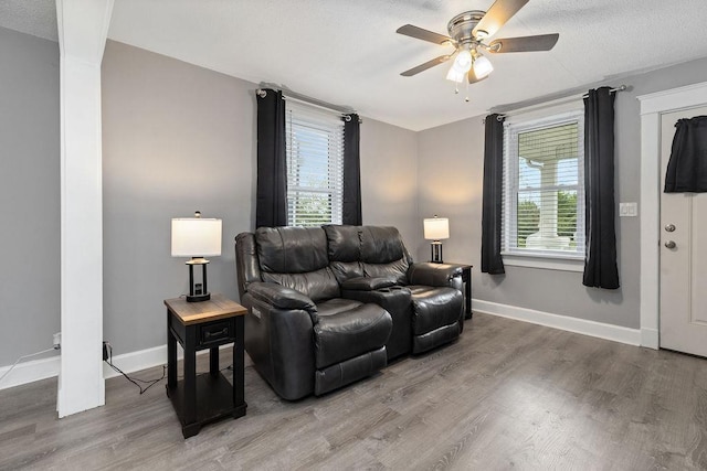 238 Charlotte Ave N, Waynesboro, VA 22980 - living area featuring ceiling fan, light wood finished floors, baseboards, and decorative columns