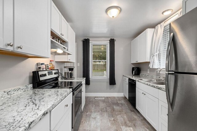 238 Charlotte Ave N, Waynesboro, VA 22980 - kitchen featuring stainless steel appliances, a sink, baseboards, wood finished floors, and white cabinets