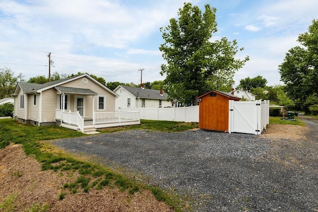 238 Charlotte Ave N, Waynesboro, VA 22980 - view of front facade with fence, covered porch, a gate, and an outdoor structure