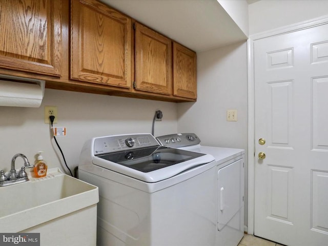  - washroom featuring washer and clothes dryer and cabinet space