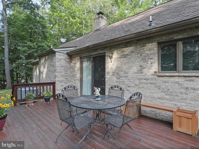  - wooden deck featuring outdoor dining area