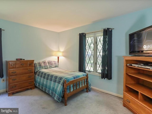  - bedroom with light colored carpet and baseboards