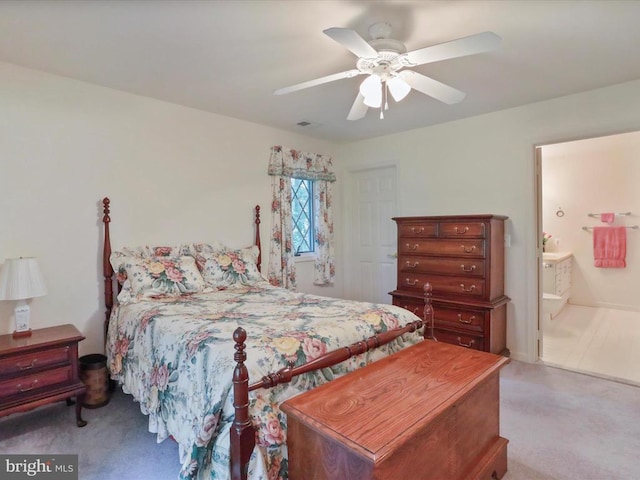  - carpeted bedroom featuring connected bathroom and ceiling fan