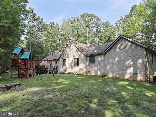  - view of home's exterior with brick siding, a playground, a yard, and crawl space