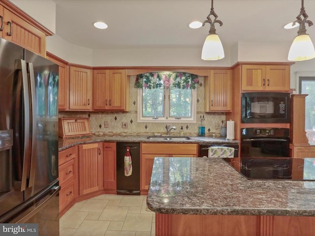  - kitchen with black appliances, decorative backsplash, dark stone countertops, decorative light fixtures, and recessed lighting
